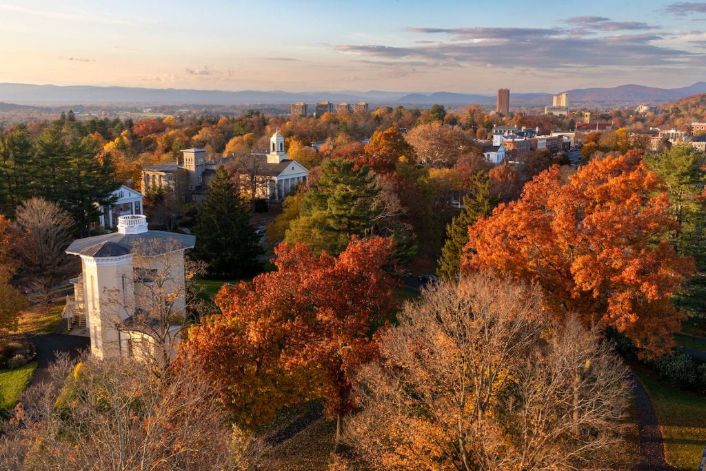 aerial view of the Amherst campus in autumn, with trees in vibrant colors of orange, red, and brown