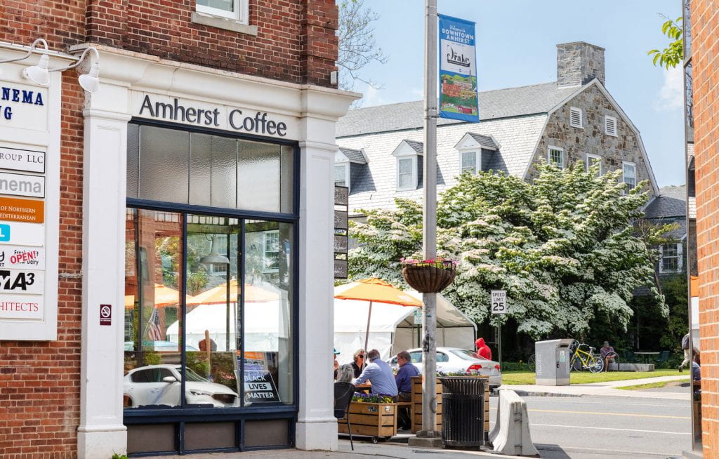 Amherst Coffee shop in downtown Amherst, with people sitting at tables outside